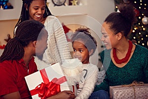 African American family exchanging Christmas gifts