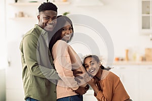 Happy African American Family Expecting Baby Standing In Kitchen Indoor