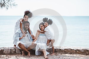 Happy African American family, Father, Mother, Two daughter enjoying and funning together in outdoor park seaside.