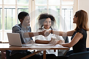 Happy African American family handshaking with realtor at meeting