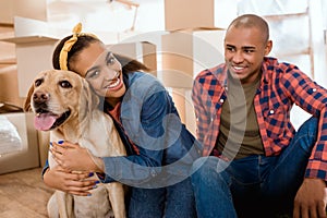 happy african american family with labrador dog moving to