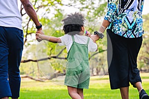 Happy African American family life concept. African American parents Father, Mother and little boy walking and have fun and