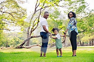 Happy African American family life concept. African American parents Father, Mother and little boy walking and have fun and