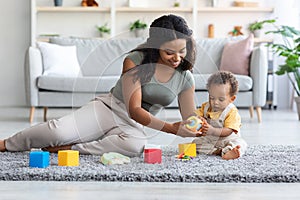 Happy African American Family, Mom And Infant Child Playing Together At Home