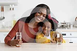 Happy African American Family Mother And Daughter Holding Glasses With Water
