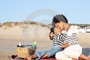 Happy African American family on picnic on beach