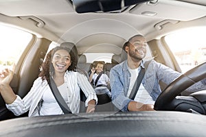 Happy african american family riding car, traveling by automobile