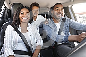 Happy African American Family With Son Sitting Inside Of Car