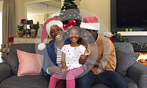 Happy african american family spending time together siting on the sofa