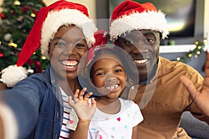 Happy african american family spending time together siting on the sofa