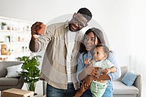 Happy African American family taking selfie together at home