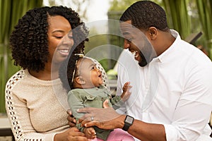 Happy African American family with their baby.