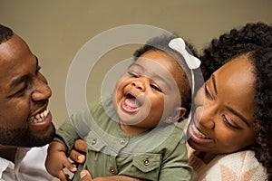 Happy African American family with their baby.