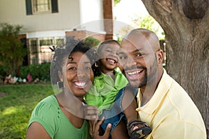 Happy African American family with their baby.