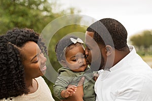 Happy African American family with their baby.