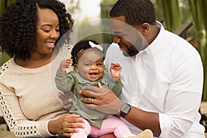 Happy African American family with their baby.