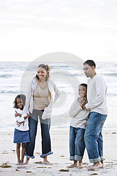 Happy African-American family together on beach