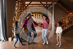 Happy African American family with two kids celebrating Christmas