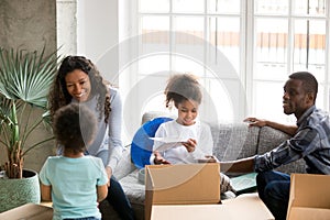 Happy African American family unpacking boxes, just moving