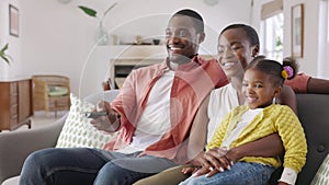 Happy african american family watching TV at home