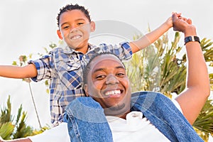 Happy African American Father and Mixed Race Son Playing At The Park