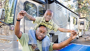 Happy African American Father and Son In Front of Their RV