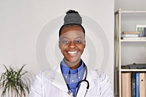 Happy african american female doctor looking at camera, head shot portrait.