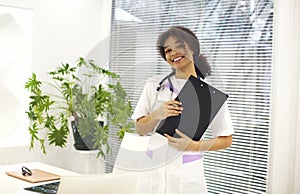 Happy african american female doctor physician wearing medical uniform with stethoscope