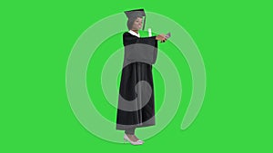 Happy African American female graduate holding diploma and making selfie on a Green Screen, Chroma Key.