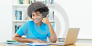 Happy african american female student learning at computer