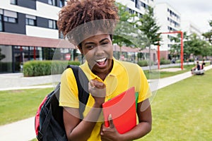 Happy african american female student outdoor on campus