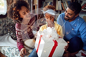 Happy African American girl celebrate Christmas wuth her family