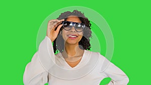 Happy African American girl chilling wearing sunglasses on a Green Screen, Chroma Key.