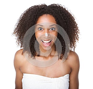 Happy african american girl with cream on nose