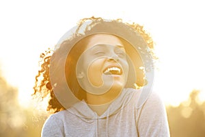 Happy african american girl laughing outdoors