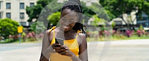 Happy african american girl with phone sending message