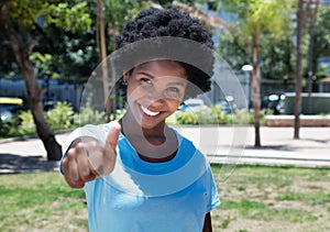 Happy african american girl showing thumb