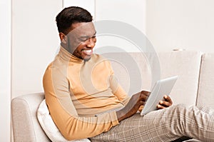 Happy Guy Using Tablet Computer Sitting On Couch At Home