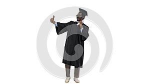 Happy african american male student in graduation robe taking ph