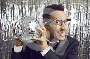 Happy African American man entertainer with disco ball