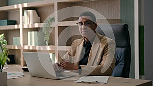 Happy African American man ethnic male entrepreneur business leader businessman employee ceo manager working on laptop