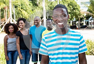 Happy african american man with group of people from Africa