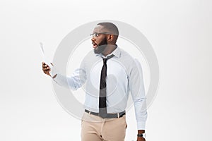 Happy African American man holding documaent paper over isolated white background with a surprise and shock face