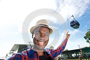 Happy african american man pointing finger to cable car