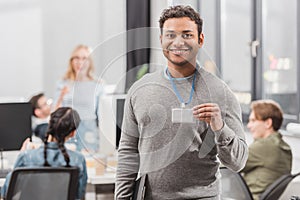 happy african american man showing name tag