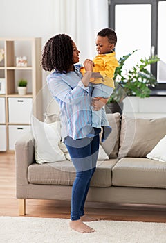 Happy african american mother with baby at home