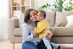 Happy african american mother with baby at home