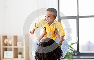 Happy african american mother with baby at home