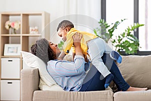Happy african american mother with baby at home