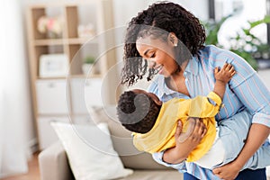 Happy african american mother with baby at home